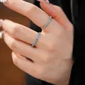 Minimalist silver eternity ring set with sparkling light blue cubic zirconia stones - Size 6