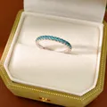 Close-up of minimalist silver eternity ring with sky blue cubic zirconia stones - Size 7