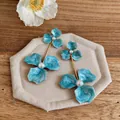 Elegant blue enamel flower drop earrings featuring white pearl accents on fabric pad - Steel Needle Style / Blue