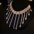 Detailed view of sparkling rhinestone tassel necklace with teardrop crystal pendants - Gold