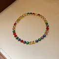 Macro view of a gold-plated bracelet with vibrant multi-colored round zircons. - 39# Bracelet