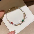 Close-up of a gold-plated bracelet with sparkling multi-colored cubic zirconia. - 41# Bracelet