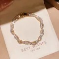 Detailed view of elegant gold-plated wavy bracelet set with sparkling cubic zirconia stones - 42# Bracelet