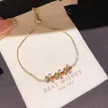Close-up detail of a gold-plated zircon flower bracelet displayed on a gift pouch - 44# Bracelet