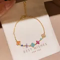 Elegant detailed close-up of a gold-plated zircon flower bracelet on a white gift pouch. - 52# Bracelet