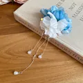 Macro view showing detail of blue and white fabric flower hair clip with pearl tassels. - Duckbill Clip (43#)