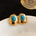 Close-up of elegant vintage gold-tone earrings featuring smooth oval turquoise resin stones - Oval Geometric Style (HE32748) / Gold