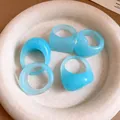 Five light blue resin geometric rings featuring marble texture displayed in a neutral dish. - Light Blue 5-Piece Set / 5 Pieces / Blue