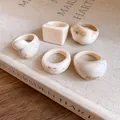 Set of minimalist resin rings with cream marble texture and geometric shapes. - Beige Textured 5-Piece Set / 5 Pieces / Beige