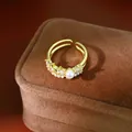 Close-up detail of an elegant gold pearl ring featuring zircon inlay and a vintage design - Gold