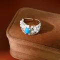 Detailed view of a vintage palace style ring with blue stone, pearls and zircons - Silver