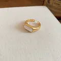 Detail view of a minimalist 18k gold plated open ring featuring a white resin inlay. - Open Ring / Gold-White