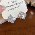 Detail of white flower earrings with zircon center on S925 silver needle display card - White