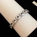 Close-up of stainless steel enamel bracelet with black shiba inu puppy pattern - Shiba Inu Style (TB163) / Silver