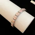 Detailed view of a stainless steel charm bracelet featuring cute enamel puppy dog patterns - Golden Retriever Style (TB163) / Silver