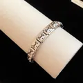 Close-up detail of stainless steel Italian charm bracelet with enamel dog pattern - Husky Style (TB163) / Silver