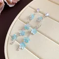 Elegant silver needle drop earrings with light blue zircon flowers and long tassels. - Silver-Blue
