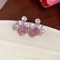 Close-up of elegant pink rose zircon flower earrings with small pearls and silver needles - Silver-Pink