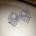 Macro detail of fan-shaped earrings with sparkling cubic zirconia and elegant white pearls - French Luxury Palace Style / Silver