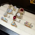 Close-up of a 9-piece set of assorted resin and rhinestone open rings in a display tray - 9-Piece Set / Silver