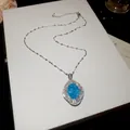 Close-up of vintage blue oval stone pendant necklace with sparkling zircon details - Silver-Blue-Oval
