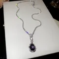 Macro view of vintage purple teardrop pendant necklace with sparkling tennis chain details - Silver-Purple