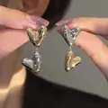 Elegant bicolor gold and silver heart dangle earrings with a high-polished mirror finish - Silver Post Heart Stud Earrings / Gold and Silver Two-tone