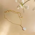 Detailed view of 18k gold-plated necklace with zircon-framed shell pendant and pearl. - Choker Necklace / Gold