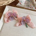 Close-up of sweet chiffon flower earrings with colorful glass beads on a tray. - Light Purple-Light Orange