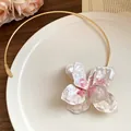 Close-up of vintage metal circular choker with painted floral pendant and hammered petals - Gold White and Pink