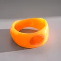Detail view of a bold chunky orange resin bangle with textured marbled oval inlay - Orange Wide Resin Bangle