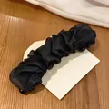 Detailed view of the elegant black pleated mesh fabric on a vertical hair claw clip - Twist Clip / Black