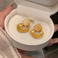 Dettaglio elegante di orecchini in oro di lusso con pietra occhio di gatto e zirconi. - Perno in Argento-Ciondolo a Rombo Traforato / Oro