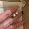 Macro view showing the sparkling zircon stone detail and silver-toned finish of the hoop earrings. - Silver (White Gold Plated)