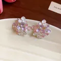 Close-up detail of sweet enamel flower stud earrings featuring purple and pink petals - Silver Style / Pink Purple