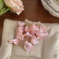 Close-up detail of romantic pink chiffon petal earrings with sparkling zircon studs - Silver Earring Post Style / Pink