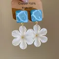 Detailed view of elegant white chiffon flower earrings with blue water-ripple tops - Style 14 (Silver Pin) / Blue & White