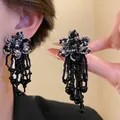 Detailed view of handmade black beaded flower earrings with elegant long tassels - Style 21 (Silver Pin) / Black