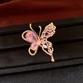 Close-up of elegant 18K gold plated butterfly earring with pink zircons on black box - Ring / Gold-Pink