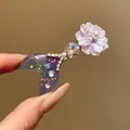 Macro detail of elegant mermaid tail hair clip decorated with pink flower and pearls - Purple