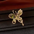 Detailed macro view of a green zircon butterfly earring with 18K rose gold plating - Ring / Gold-Green
