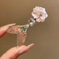 Close-up of elegant mermaid tail hair clip with pink flower and pearl accents - Pink