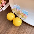 Close-up of sweet resin gradient flower earrings with large yellow round beads for summer - Floral Round Bead Shape / Yellow