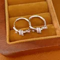 Close-up of elegant 14k gold plated zircon knot hoop earrings in a wooden jewelry box - Silver
