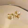 Detailed view of 18K gold-plated hoop earrings featuring a brushed metal texture. - 圆形拉丝款式(HE32141) / Gold