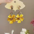 Macro detail shot of yellow enamel flower drop earrings with elegant golden finish. - Silver Earring Post - Yellow