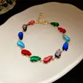 Detail of teardrop-shaped colorful zircon stones on gold-plated link bracelet - Gold-Multicolor