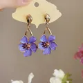 Macro view showing the intricate purple enamel and gold detail of these floral drop earrings - Silver Earring Post - Purple
