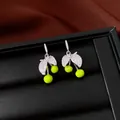 Detail view of silver earrings with leaf design, zircon stones and vibrant green beads. - Fresh Cherry Apple Style / Silver-Green