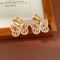 Detailed view of 18K gold-plated butterfly clip-on earrings with sparkling zircon stones - Clip-on Earrings / Gold
